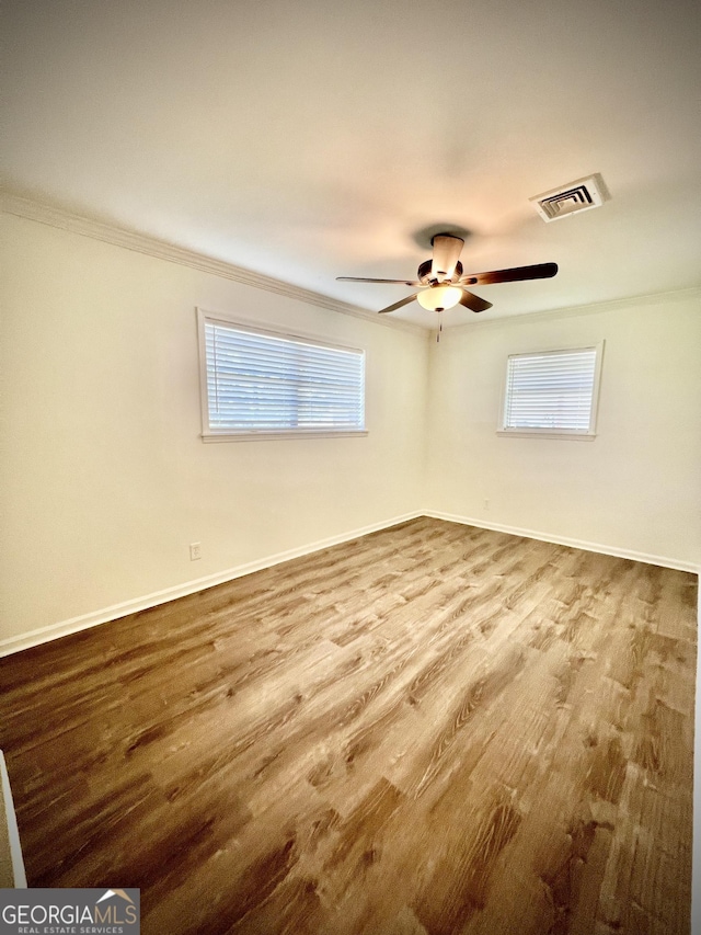 108 Plum St, Dublin, GA 31021 - spare room featuring crown molding, baseboards, plenty of natural light, wood finished floors, and ceiling fan