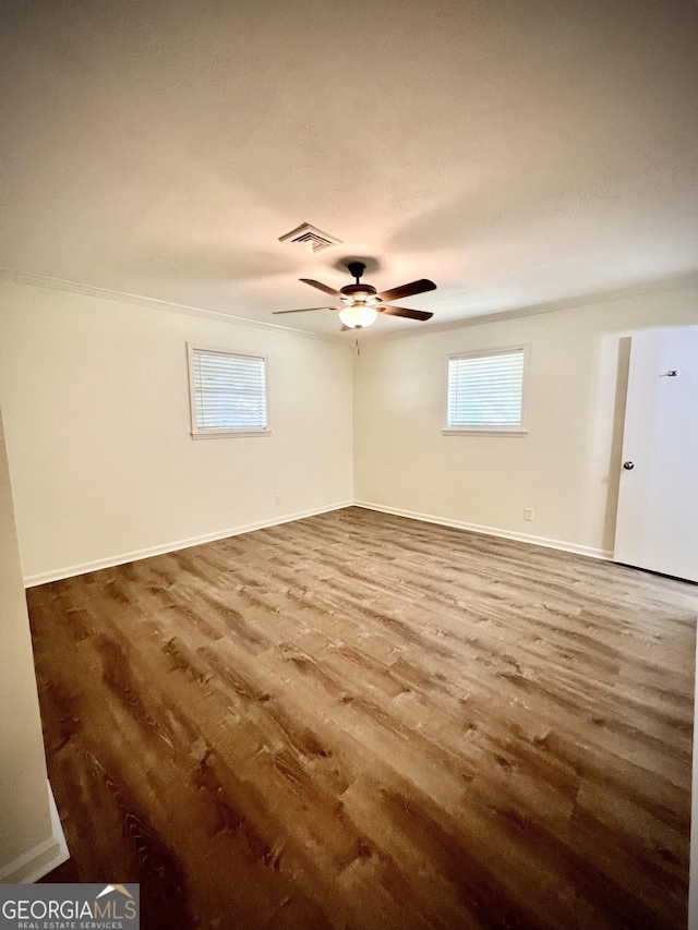 108 Plum St, Dublin, GA 31021 - unfurnished room featuring wood finished floors, a ceiling fan, and baseboards