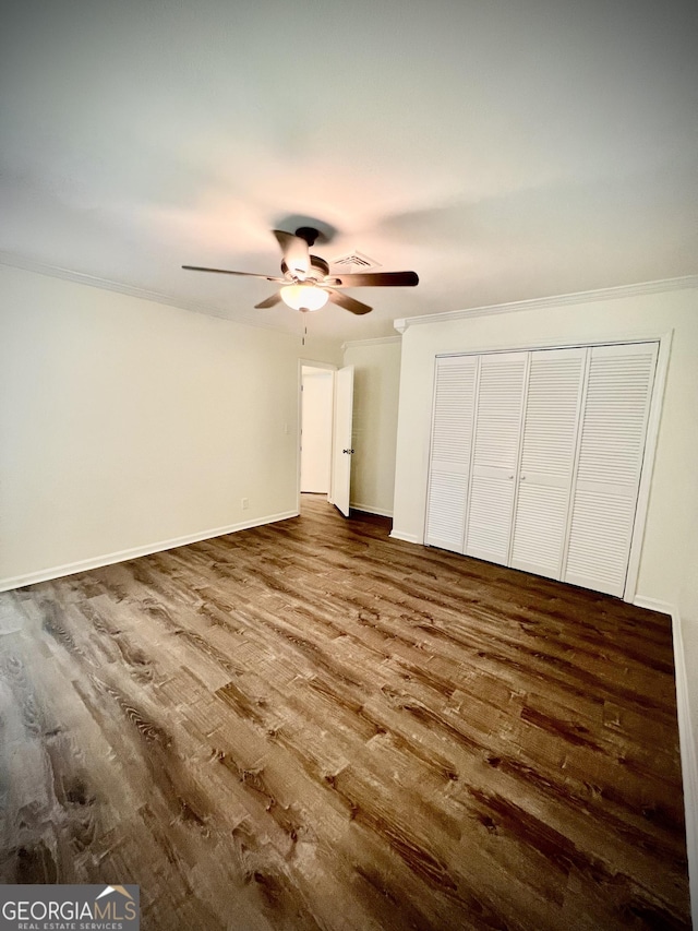 108 Plum St, Dublin, GA 31021 - unfurnished bedroom with wood finished floors, crown molding, baseboards, ceiling fan, and a closet