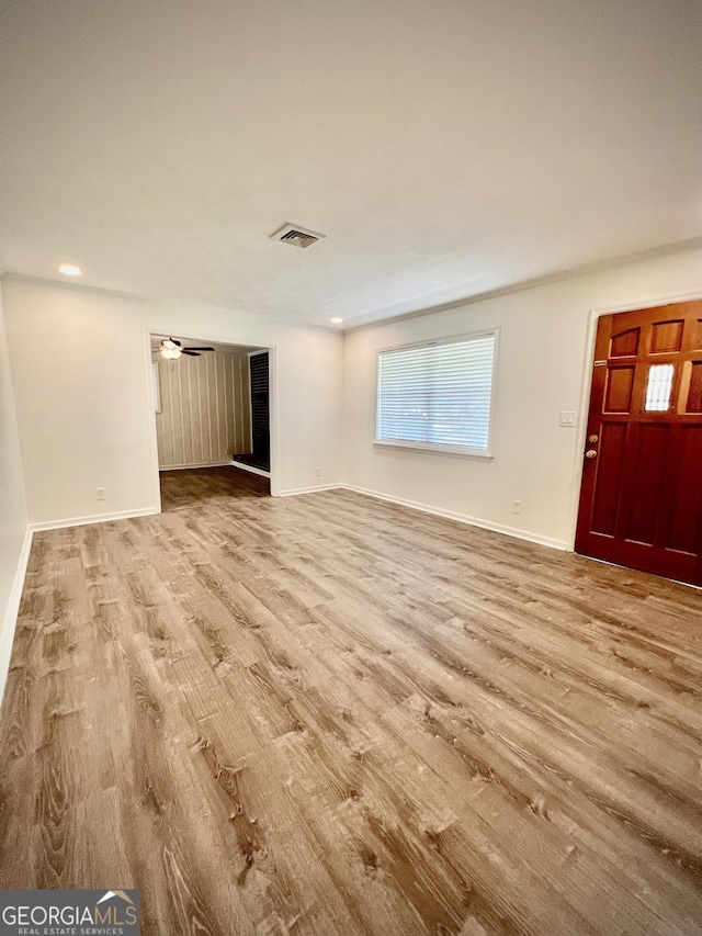 108 Plum St, Dublin, GA 31021 - unfurnished living room with wood finished floors, baseboards, and recessed lighting