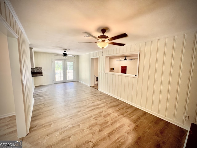 108 Plum St, Dublin, GA 31021 - unfurnished living room featuring wood finished floors, a ceiling fan, and a decorative wall