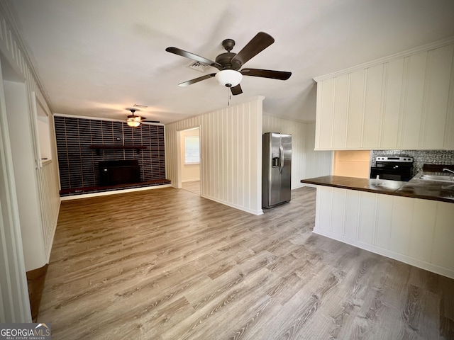108 Plum St, Dublin, GA 31021 - kitchen featuring appliances with stainless steel finishes, dark countertops, ceiling fan, open floor plan, and a sink
