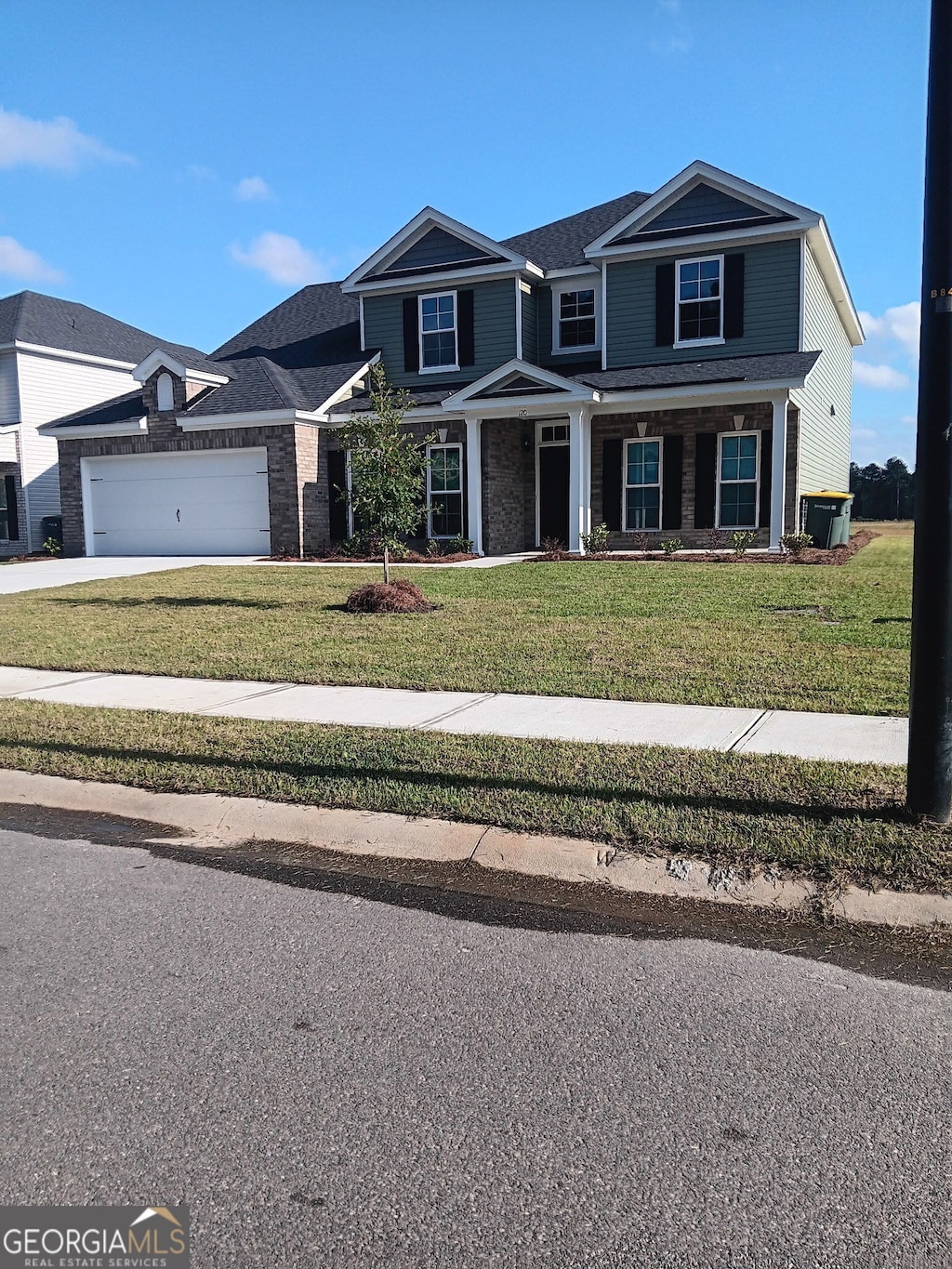 120 Chalk Farm Way, Bloomingdale, GA 31302 - view of front of property featuring a front yard, an attached garage, and driveway