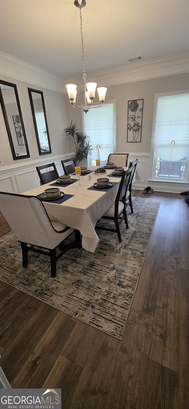 120 Chalk Farm Way, Bloomingdale, GA 31302 - dining area with crown molding, a decorative wall, dark wood-style flooring, a chandelier, and a wainscoted wall