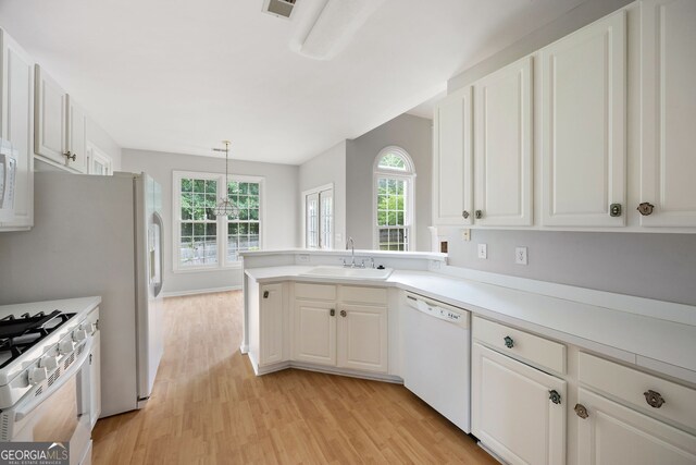 4801 Devonhurst Way, Powder Springs, GA 30127 - kitchen featuring white appliances, a sink, light wood-style floors, and healthy amount of natural light