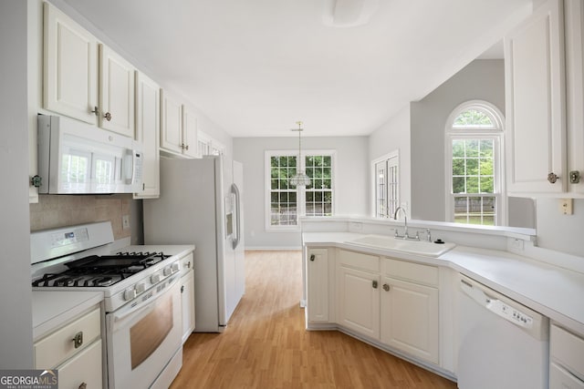 4801 Devonhurst Way, Powder Springs, GA 30127 - kitchen featuring white appliances, a sink, light wood-style floors, and light countertops
