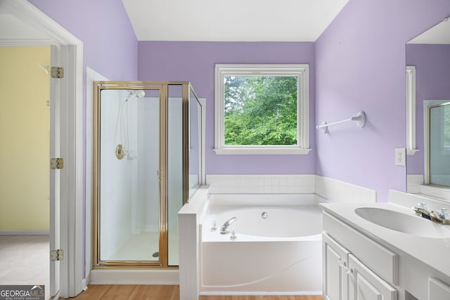 4801 Devonhurst Way, Powder Springs, GA 30127 - bathroom featuring a bath, vanity, a stall shower, and wood finished floors