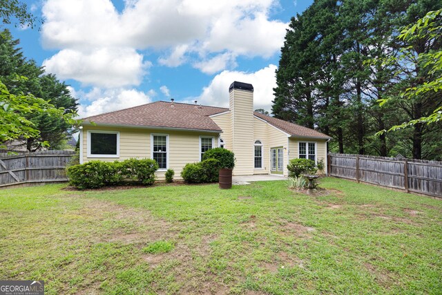 4801 Devonhurst Way, Powder Springs, GA 30127 - back of property featuring a patio, a chimney, and a shingled roof