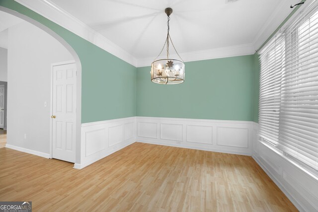 4801 Devonhurst Way, Powder Springs, GA 30127 - unfurnished room with arched walkways, light wood finished floors, a wainscoted wall, a chandelier, and ornamental molding