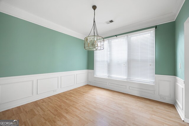 4801 Devonhurst Way, Powder Springs, GA 30127 - empty room featuring ornamental molding, a chandelier, a wainscoted wall, light wood finished floors, and a decorative wall