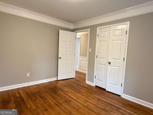 2751 Wayman Dr, Gainesville, GA 30506 - unfurnished bedroom featuring dark wood finished floors, crown molding, baseboards, and a closet