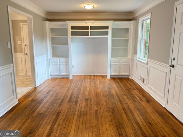2751 Wayman Dr, Gainesville, GA 30506 - unfurnished dining area with a decorative wall, dark wood finished floors, wainscoting, and ornamental molding