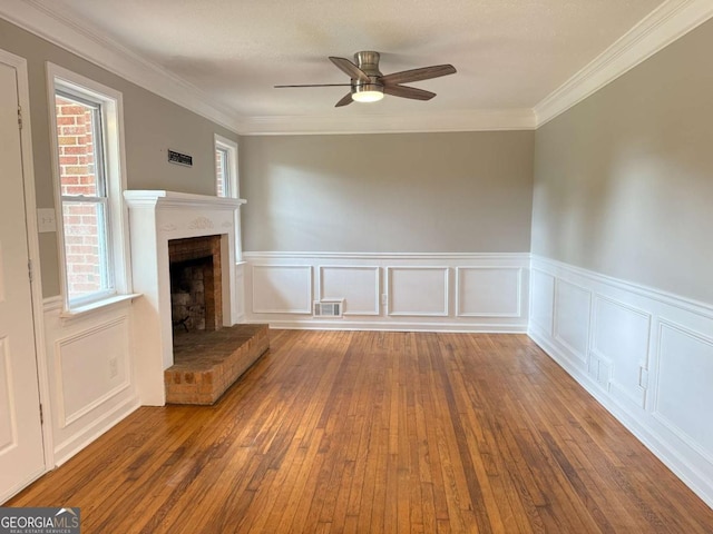2751 Wayman Dr, Gainesville, GA 30506 - unfurnished living room with a ceiling fan, a brick fireplace, hardwood / wood-style flooring, wainscoting, and ornamental molding