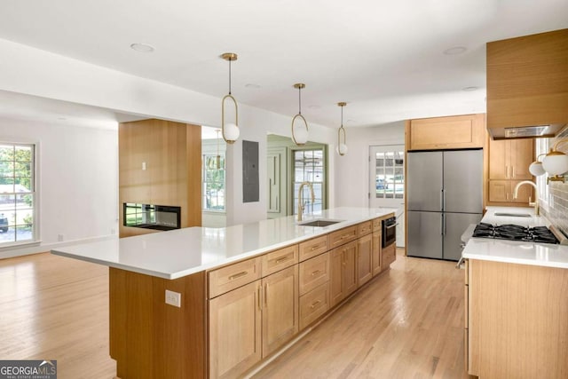 762 Rockbridge Rd NW, Lilburn, GA 30047 - kitchen with stainless steel appliances, a sink, light wood-type flooring, and light countertops