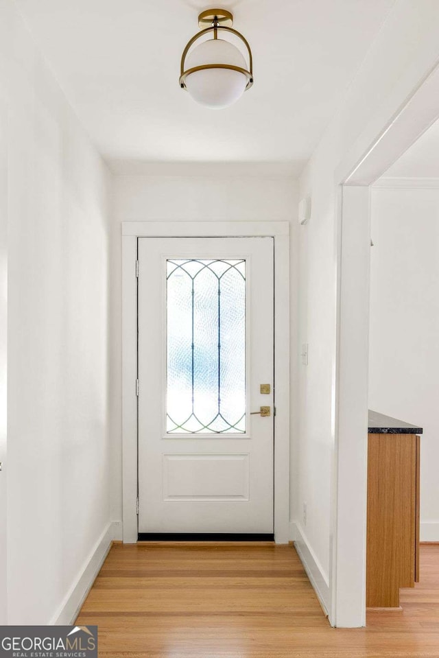 762 Rockbridge Rd NW, Lilburn, GA 30047 - doorway to outside with light wood finished floors and baseboards