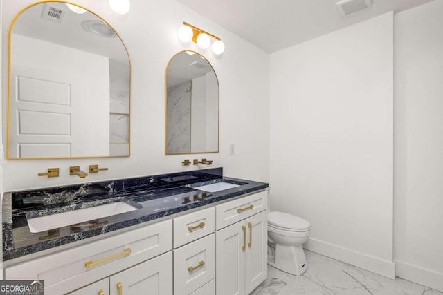 762 Rockbridge Rd NW, Lilburn, GA 30047 - full bath featuring marble look tiles, double vanity, toilet, and baseboards