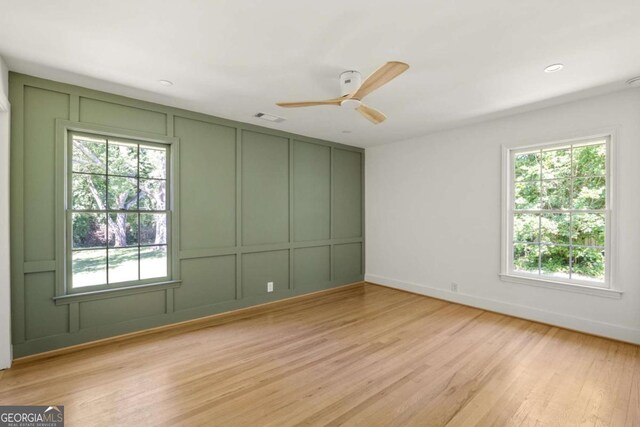 762 Rockbridge Rd NW, Lilburn, GA 30047 - empty room featuring a decorative wall, light wood-type flooring, ceiling fan, baseboards, and recessed lighting