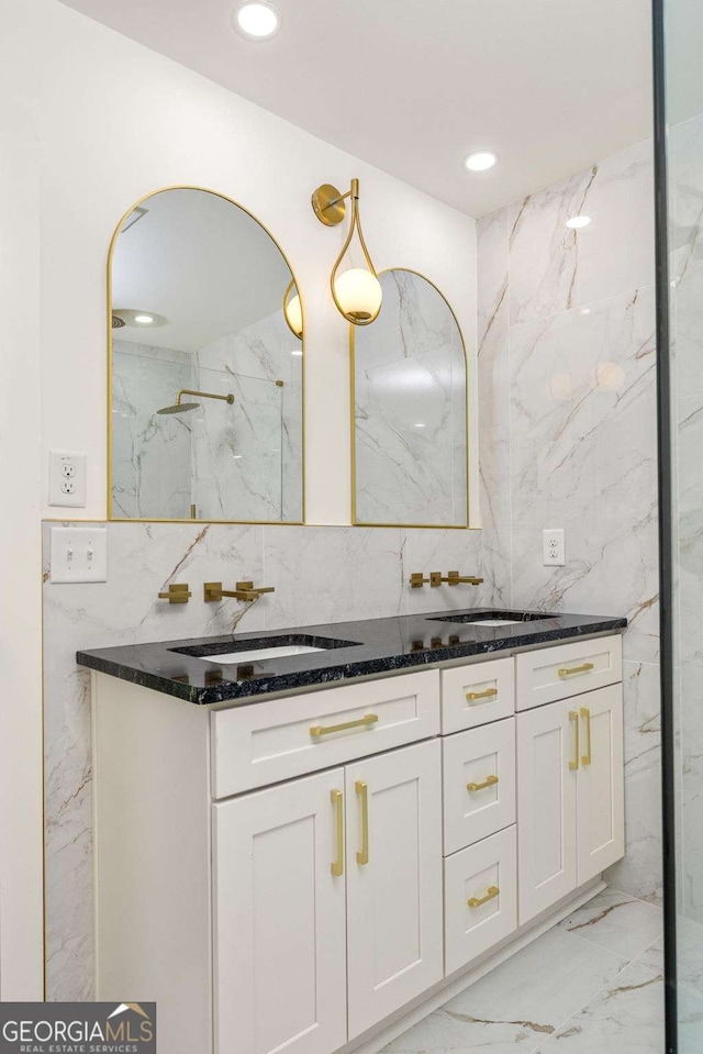 762 Rockbridge Rd NW, Lilburn, GA 30047 - full bath featuring double vanity, marble tiled flooring, tile walls, recessed lighting, and backsplash