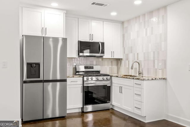762 Rockbridge Rd NW, Lilburn, GA 30047 - kitchen featuring stainless steel appliances, a sink, light stone counters, white cabinetry, and recessed lighting