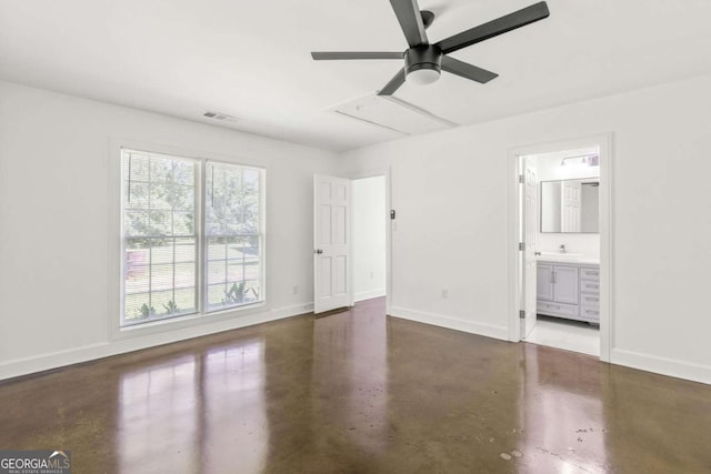 762 Rockbridge Rd NW, Lilburn, GA 30047 - unfurnished bedroom featuring finished concrete floors, baseboards, ensuite bath, attic access, and a ceiling fan