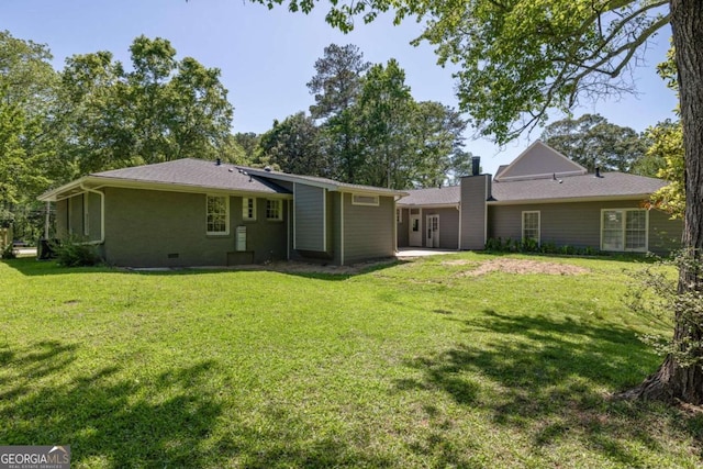 762 Rockbridge Rd NW, Lilburn, GA 30047 - rear view of property with a lawn, a chimney, and crawl space