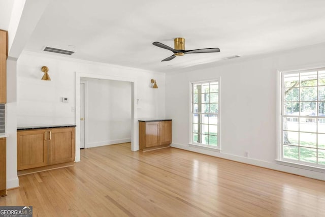 762 Rockbridge Rd NW, Lilburn, GA 30047 - unfurnished living room featuring light wood-style floors, plenty of natural light, and a ceiling fan