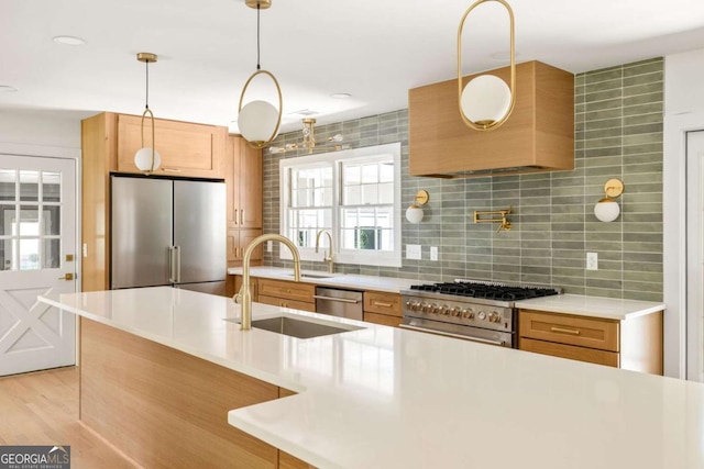 762 Rockbridge Rd NW, Lilburn, GA 30047 - kitchen featuring appliances with stainless steel finishes, a sink, light countertops, backsplash, and pendant lighting