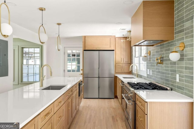 762 Rockbridge Rd NW, Lilburn, GA 30047 - kitchen with appliances with stainless steel finishes, a sink, wall chimney range hood, and backsplash