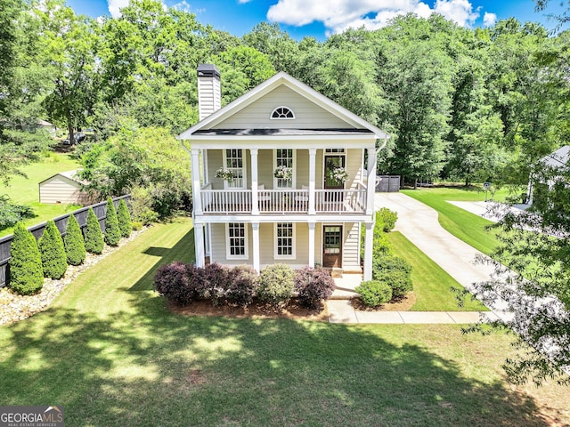 90 Middle St, Senoia, GA 30276 - greek revival inspired property featuring covered porch, a chimney, a front yard, and concrete driveway