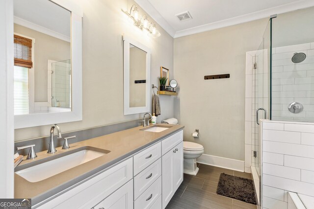 90 Middle St, Senoia, GA 30276 - bathroom with double vanity, a stall shower, toilet, crown molding, and baseboards