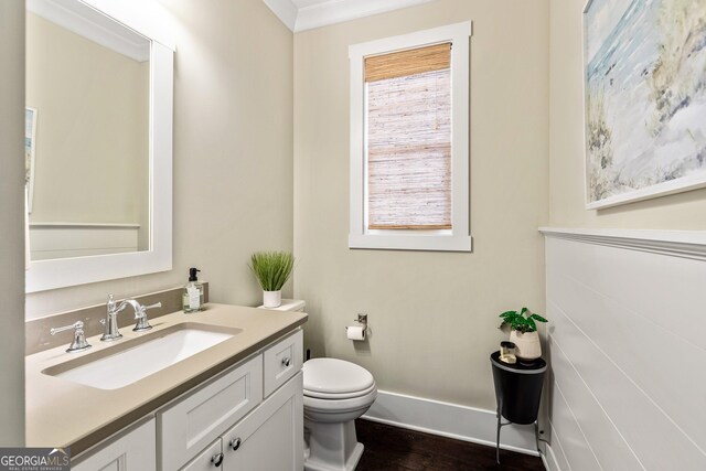 90 Middle St, Senoia, GA 30276 - half bathroom featuring vanity, toilet, wood finished floors, and crown molding