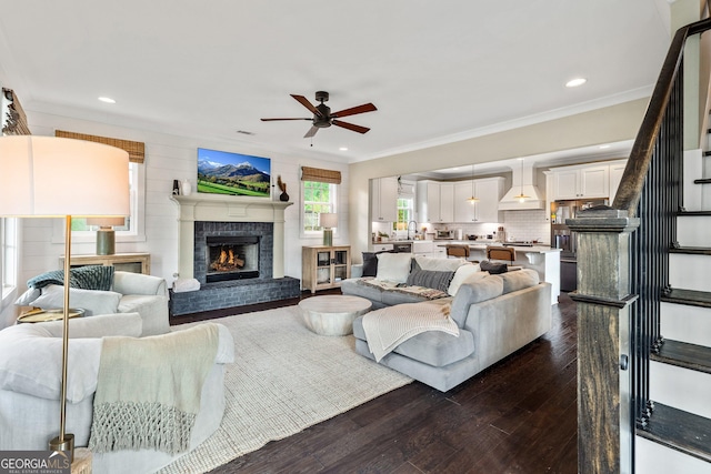 90 Middle St, Senoia, GA 30276 - living area with a ceiling fan, dark wood-style flooring, crown molding, a fireplace, and recessed lighting