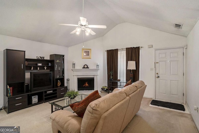 4378 Chestnut Oaks Trce, Lithonia, GA 30038 - carpeted living area featuring lofted ceiling, a ceiling fan, a lit fireplace, and baseboards