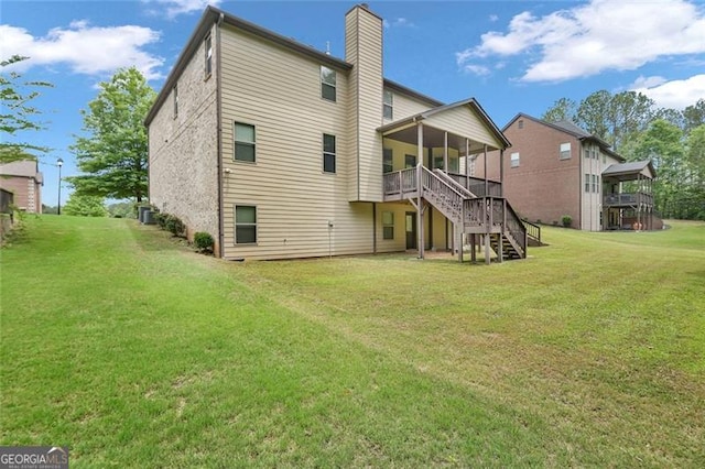 271 Learwood, Atlanta, GA 30349 - rear view of property featuring stairs, a chimney, a lawn, a deck, and a sunroom