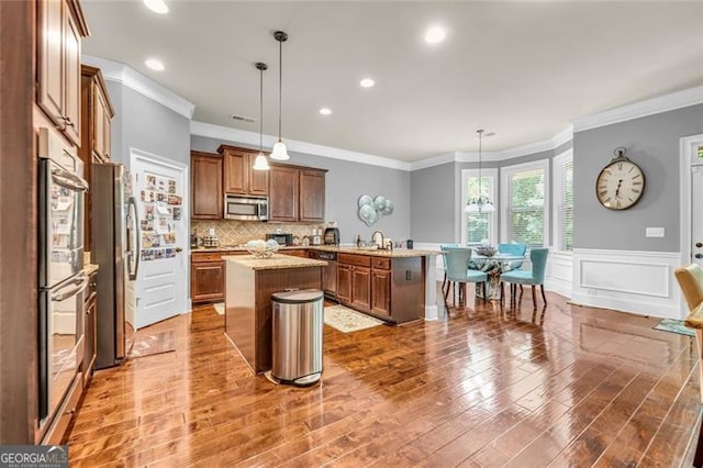 271 Learwood, Atlanta, GA 30349 - kitchen with stainless steel appliances, a kitchen island, ornamental molding, a peninsula, and a sink