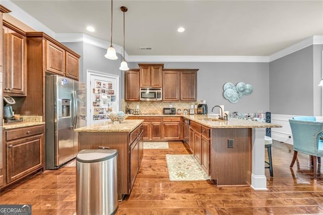 271 Learwood, Atlanta, GA 30349 - kitchen with appliances with stainless steel finishes, crown molding, a peninsula, a breakfast bar area, and a kitchen island