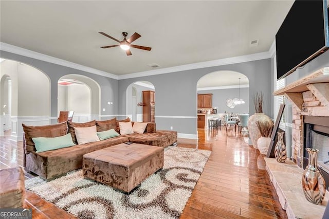 271 Learwood, Atlanta, GA 30349 - living area featuring a ceiling fan, ornamental molding, arched walkways, light wood-type flooring, and a fireplace