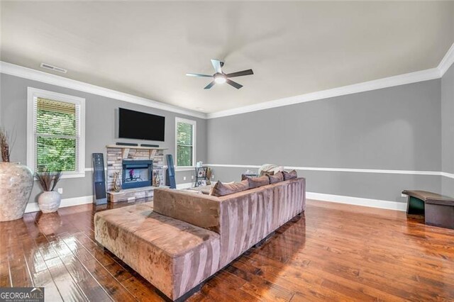 271 Learwood, Atlanta, GA 30349 - living room with a ceiling fan, dark wood-style floors, plenty of natural light, crown molding, and a stone fireplace