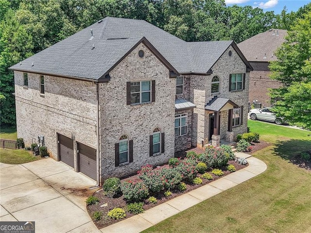 271 Learwood, Atlanta, GA 30349 - view of front of home with a garage, concrete driveway, a front lawn, a shingled roof, and brick siding