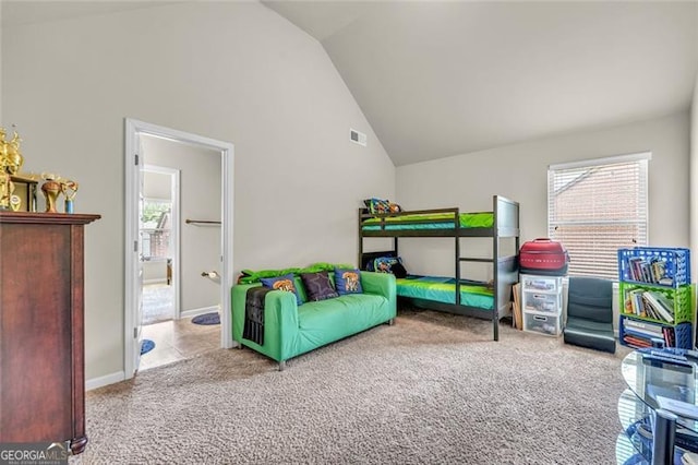 271 Learwood, Atlanta, GA 30349 - bedroom featuring lofted ceiling, multiple windows, carpet floors, baseboards, and connected bathroom