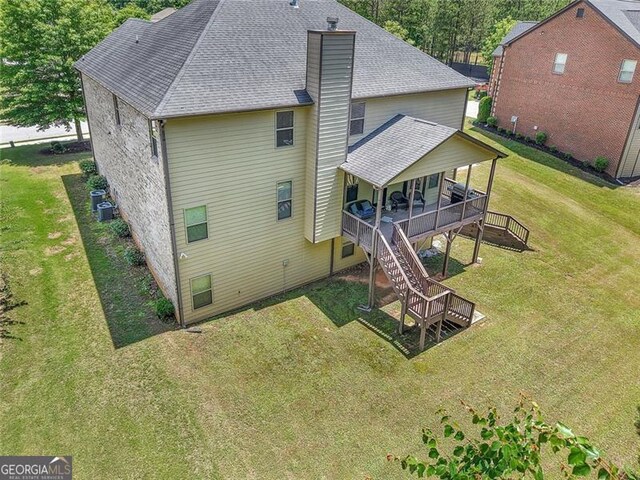271 Learwood, Atlanta, GA 30349 - rear view of house featuring a yard, stairs, a shingled roof, a chimney, and central air condition unit