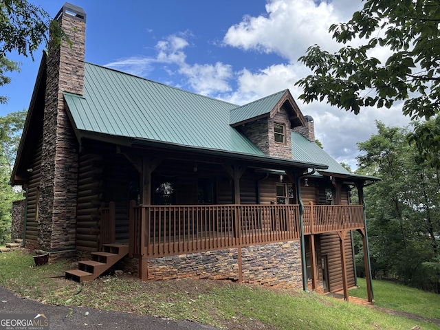 435 Ranch Mountan Dr, Dahlonega, GA 30533 - view of front of house featuring a chimney, metal roof, stone siding, and a porch