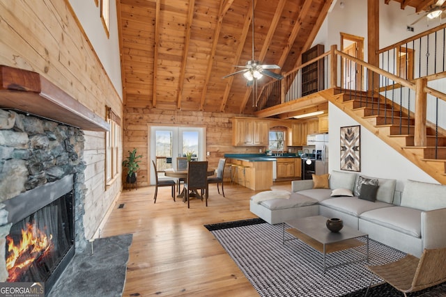 435 Ranch Mountan Dr, Dahlonega, GA 30533 - living room with high vaulted ceiling, wood ceiling with exposed beams, light wood-style floors, ceiling fan, and stairs