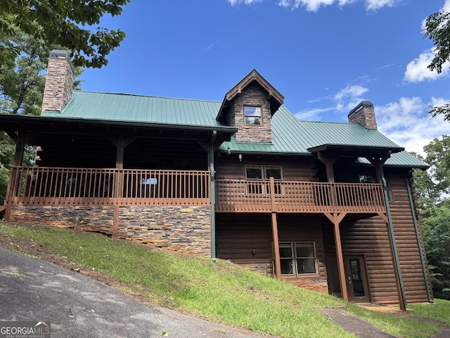 435 Ranch Mountan Dr, Dahlonega, GA 30533 - view of front facade with a chimney, stone siding, and metal roof