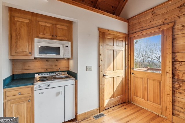 435 Ranch Mountan Dr, Dahlonega, GA 30533 - kitchen with white microwave, dark countertops, light wood-style floors, and a sink