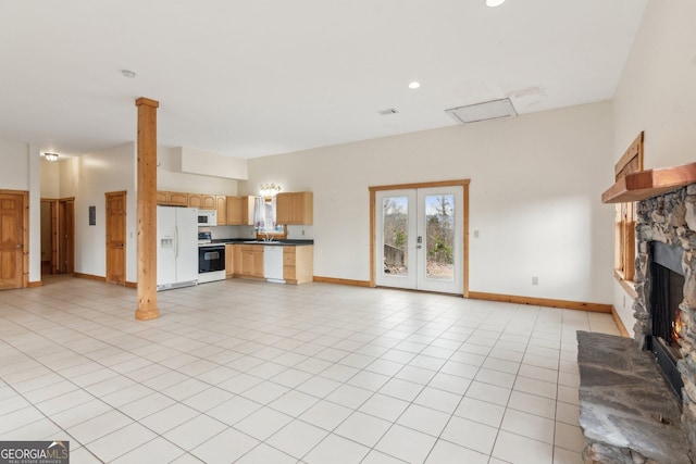 435 Ranch Mountan Dr, Dahlonega, GA 30533 - unfurnished living room featuring a stone fireplace, baseboards, a sink, recessed lighting, and light tile patterned flooring