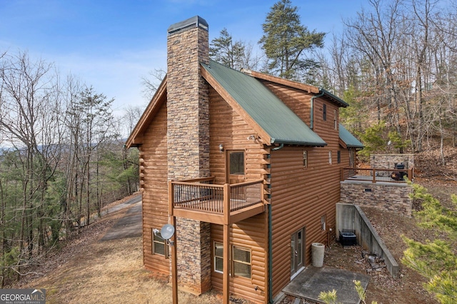 435 Ranch Mountan Dr, Dahlonega, GA 30533 - view of home's exterior featuring a chimney, metal roof, cooling unit, a balcony, and log exterior