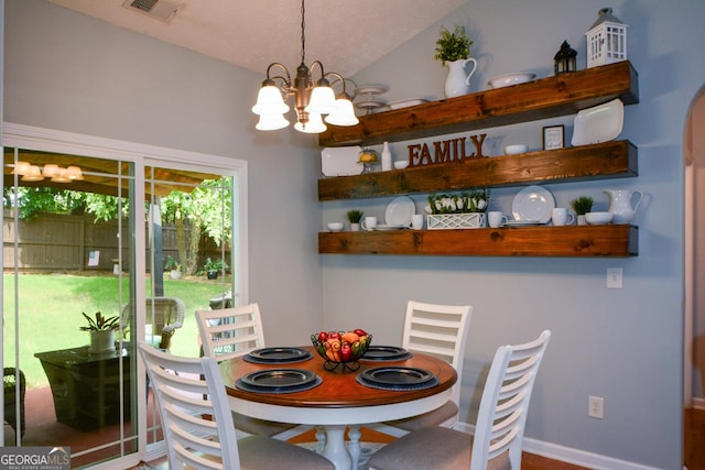 9013 Aldbury Dr, Locust Grove, GA 30248 - dining area with a chandelier, lofted ceiling, and baseboards