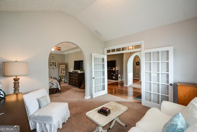 9013 Aldbury Dr, Locust Grove, GA 30248 - carpeted living room featuring arched walkways, vaulted ceiling, french doors, and baseboards