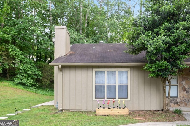 189 Timber Creek Ln, Marietta, GA 30060 - view of side of home with a chimney, a lawn, and a shingled roof